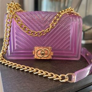 Pink jelly purse, with gold chain strap.